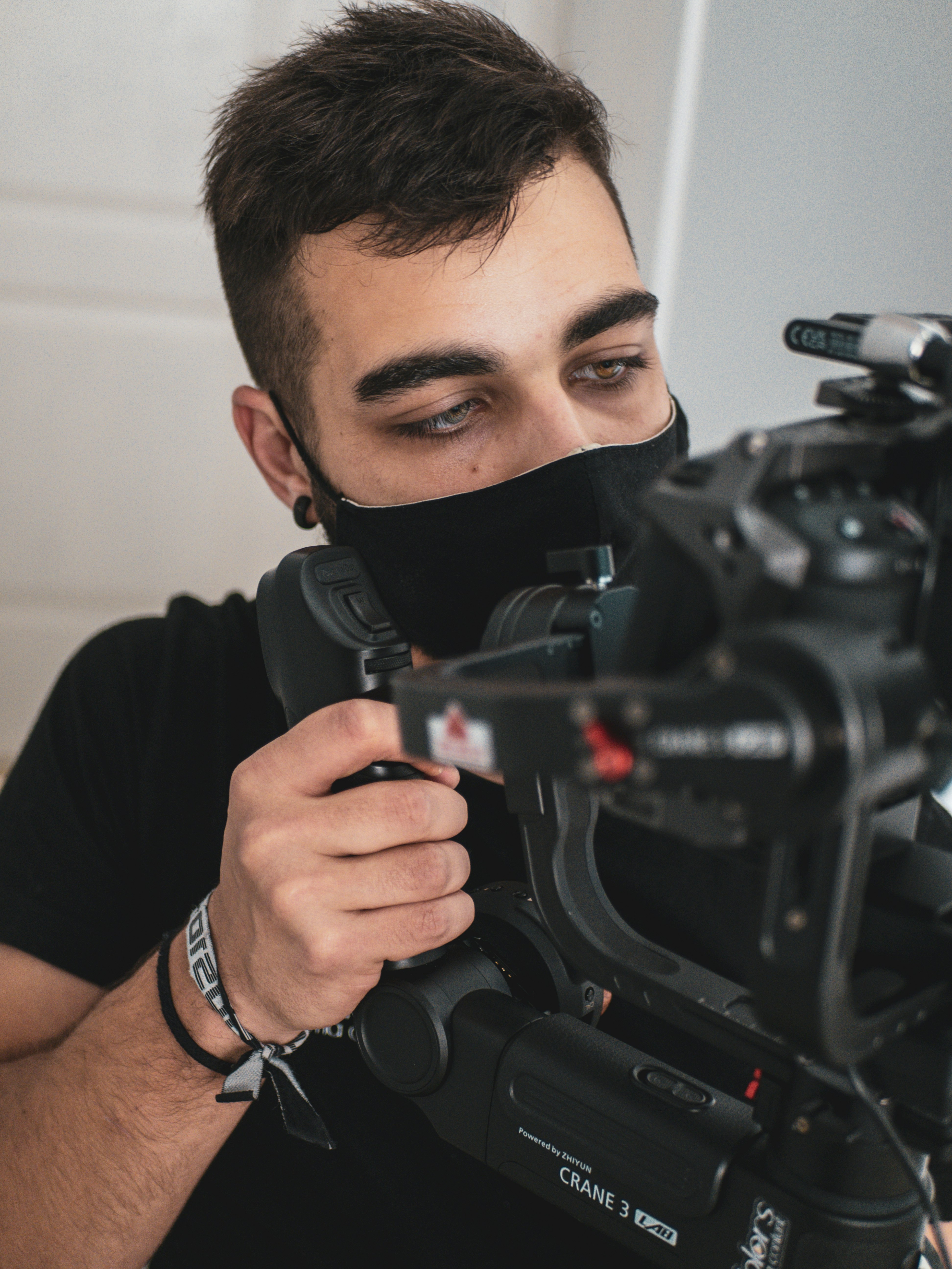 man in black shirt holding black video camera